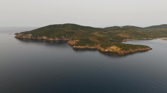 Aerial Drone Shot Flying Over Calm Aegean Sea Coastline Of Paliouri, Kassandra, Halkidiki, Greece At Sunrise.