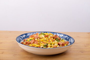 The sausage stir-fried with corn kernels on the plate