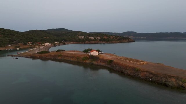 Aerial Drone Circling Shot Of Lone Building And Aegean Sea In Paliouri, Halkidiki, Greece At Sunrise.
