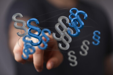 Abstract image of a hand interacting with 3D paragraph symbols, representing legal concepts, law,...