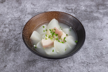 Pork and radish soup in a porcelain bowl
