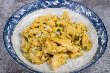 Scrambled eggs with crushed green peppers on the plate