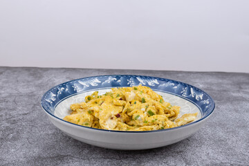 Scrambled eggs with crushed green peppers on the plate