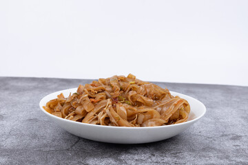 The fried rice noodles on the plate