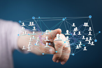 Hand interacts with a digital network of connected people, illustrating global communication and...