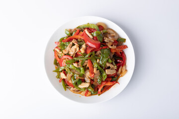 The stir-fried meat with green and red peppers on the plate