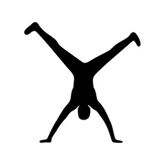 Black silhouette of person performing a handstand with legs spread apart