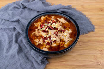 Sichuan-style boiled meat slices in a porcelain bowl