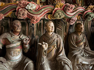 Clay sculpture of Buddhist monks at historical Guanyin Hall in Liangjiazhuang Village, Changzhi, Shanxi, China, known for extraordinary Ming Dynasty suspended sculptures. National heritage.