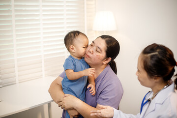 An overweight Asian woman brings her one-year-old son to consult a health expert in a private office. The scene emphasizes family care, professional guidance, wellness improvement