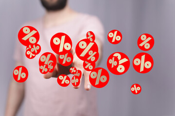 Image of a man's hands showcasing numerous red circles with percentage symbols, ideal for sale,...