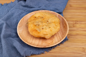 The fried food, scallion meat Patty, on a wooden plate