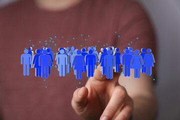 Image depicts a hand interacting with a digital network representing diverse people, symbolizing teamwork and connection.