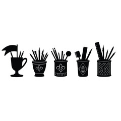 Black silhouette desk organizers with art supplies