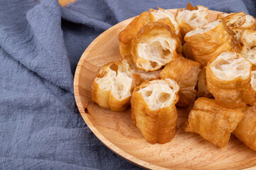 Handmade fried dough sticks in a wooden plate