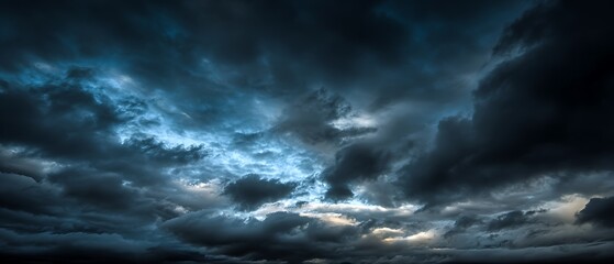Obraz premium dynamic blue sky scene with contrasting dark and light areas 
