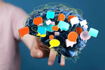 Abstract image of a brain with colorful speech bubbles, symbolizing communication, ideas, and thoughts.