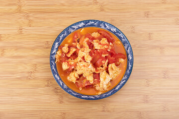 The scrambled eggs with tomatoes on the plate