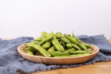 Fresh edamame in a wooden plate