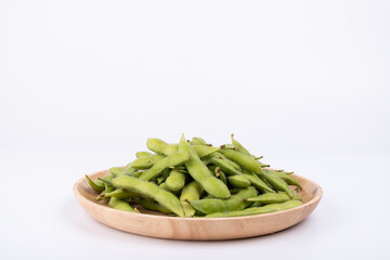 Fresh edamame in a wooden plate