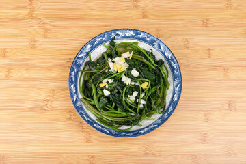 The stir-fried sweet potato leaves on the plate