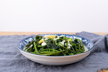 The stir-fried sweet potato leaves on the plate