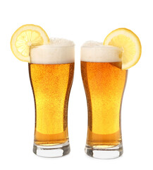 Glasses of fresh light beer with lemon slices on white background