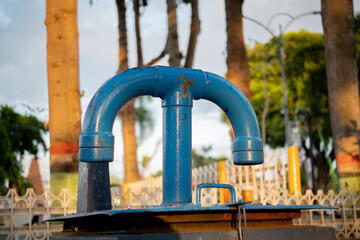 blue T shaped iron water pipe taken from the side