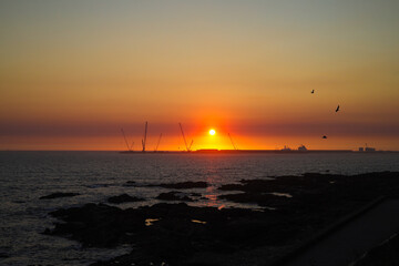Sunset on the beach of Matosinhos with the port of Porto de Leixões in the background, Portugal