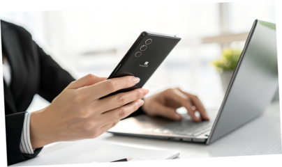 Modern professional multitasking using mobile and laptop devices for streamlined workflow under
