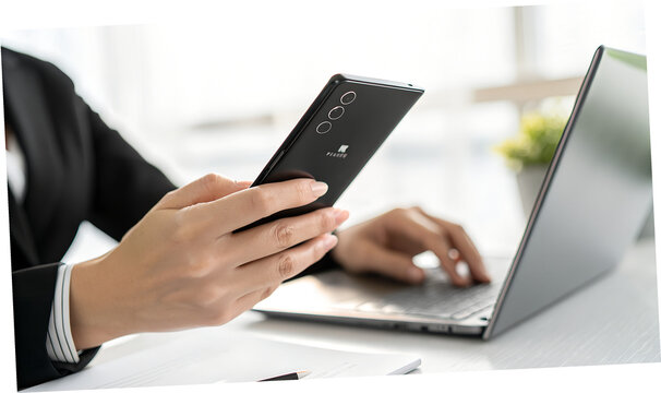 Modern professional multitasking using mobile and laptop devices for streamlined workflow under