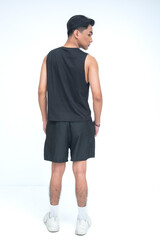 A mysterious young Asian man captured from a back shot, standing tall and looking to the side, radiating quiet confidence and intrigue. Isolated on a white background.