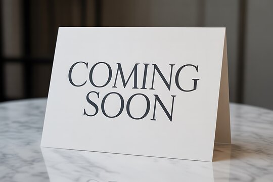 Elegant 'Coming Soon' announcement card on a marble surface creating anticipation for new arrivals or events