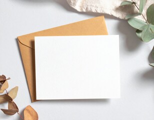 Elegant Invitation Card with Kraft Envelope and Eucalyptus Sprigs on White Background