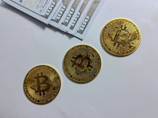 Gold bitcoins and banknotes on white background. Business concept.