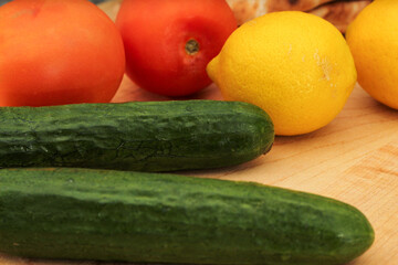 Whole Lemons, Cucumber, and Tomato on Wooden Cutting Board, Colorful Display