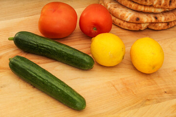 Whole Lemons, Cucumber, and Tomato on Wooden Cutting Board, Colorful Display