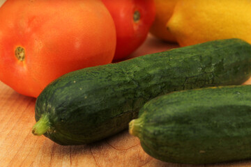 Whole Lemons, Cucumber, and Tomato on Wooden Cutting Board, Colorful Display