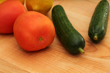 Whole Lemons, Cucumber, and Tomato on Wooden Cutting Board, Colorful Display