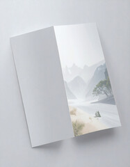 A serene landscape photograph showcasing a misty mountain range and a flowing river.