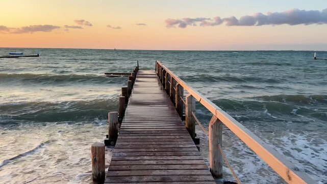 sunset in warm autumn light on old wooden Pier Leading into the Sea
 - Powered by Adobe
