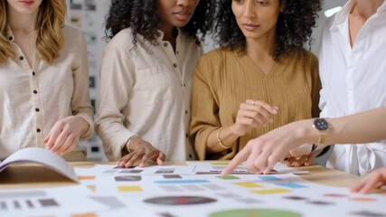 Diverse group of women collaborating, focused on a shared project, embodying teamwork and unity in a professional setting, perfect for International Women's Day - Powered by Adobe