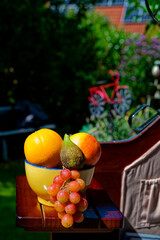 Bowl with various fruits on the table of a beach chair.