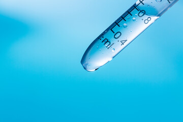 Science experiment beaker on blue background close up,Blue science experiment glass tube,Researchers with chemistry test tubes in a liquid glass lab for analytical, medical.