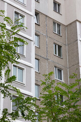 High-rise apartment buildings surrounded by greenery in a residential area showcasing urban living and property dynamics