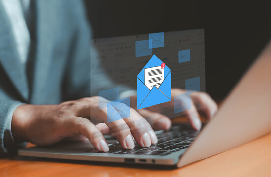 Hands typing on laptop with digital email notification icon, symbolizing online communication, business messaging, email marketing, corporate correspondence, inbox management, and digital connectivity