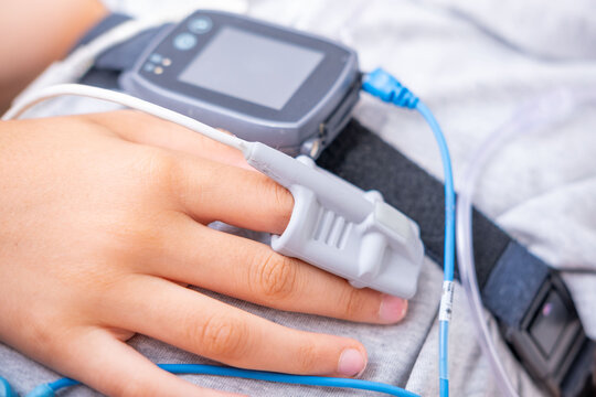 Patient finger with Pulse oximeter monitoring oxygen saturation level monitoring, finger sensor medical device, SpO2 measurement, EMS stimulator, healthcare technology, medical examination equipment