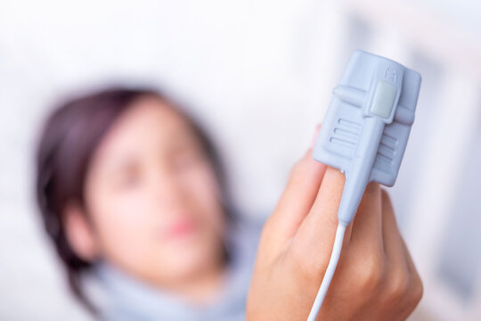 Patient finger with Pulse oximeter monitoring oxygen saturation level monitoring, finger sensor medical device, SpO2 measurement, EMS stimulator, healthcare technology, medical examination equipment