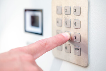 person using keypad represents system for secure entry, password protection, and restricted access, multi-factor authentication, smart locks, Privacy and convenience, modern safety technology device