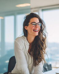 Bright portrait of a young woman in a modern office setting enjoying her workday